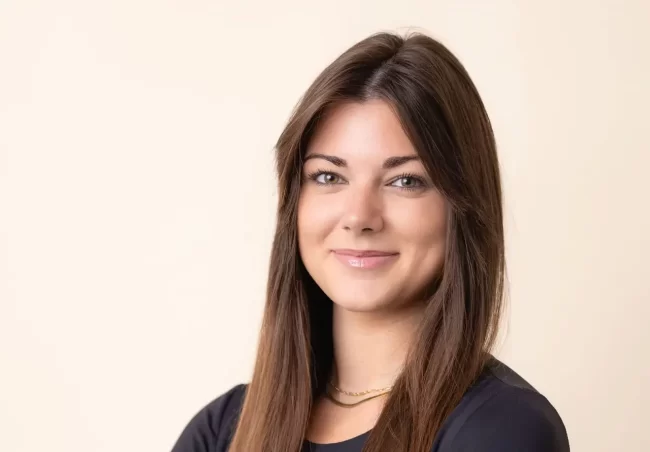 A professional headshot of a Realtor with clean lighting and background, emphasizing quality differences